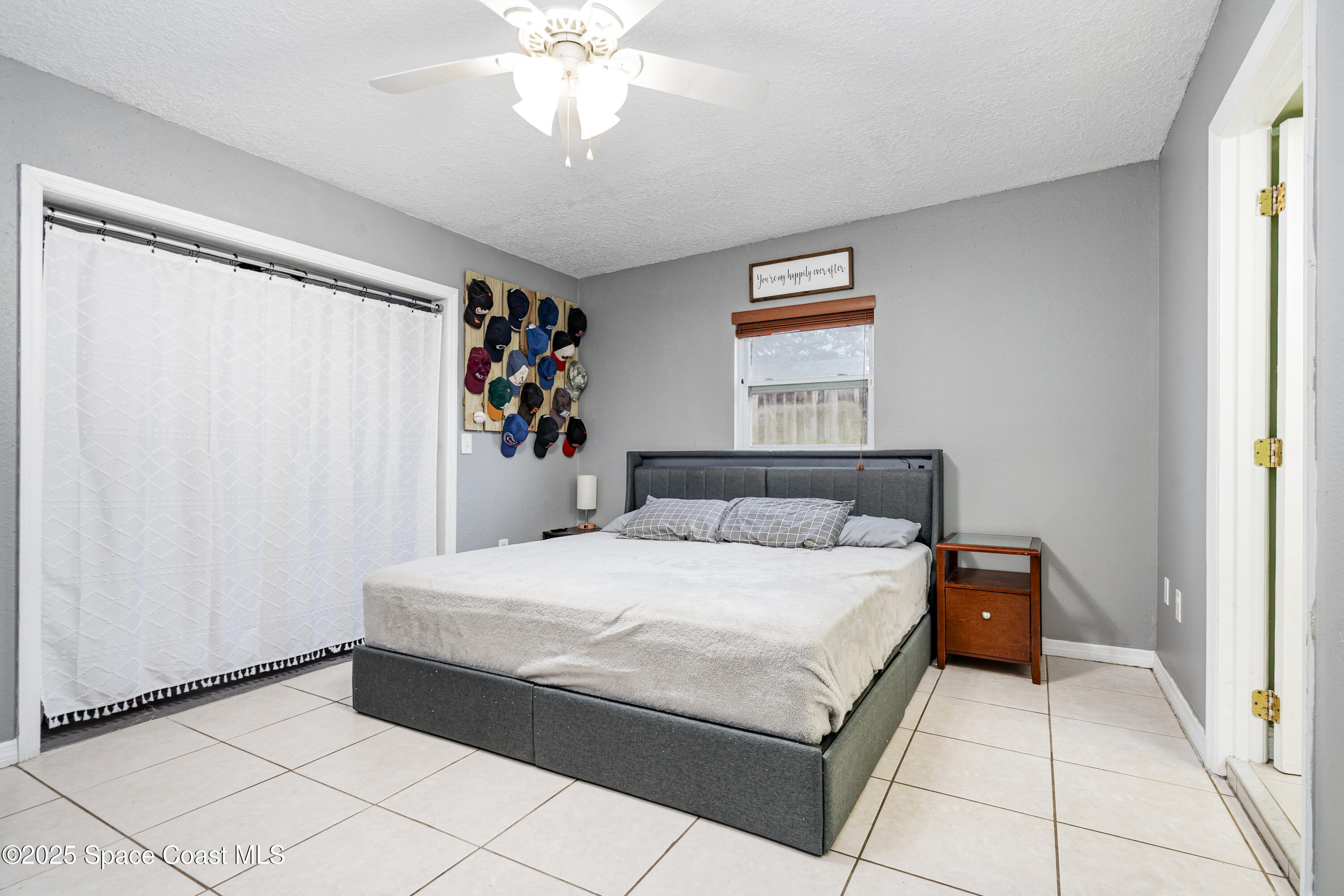 4120 Duke Street Melbourne, FL 32901 - Photo 12 of 29 a bedroom with a bed and a chandelier