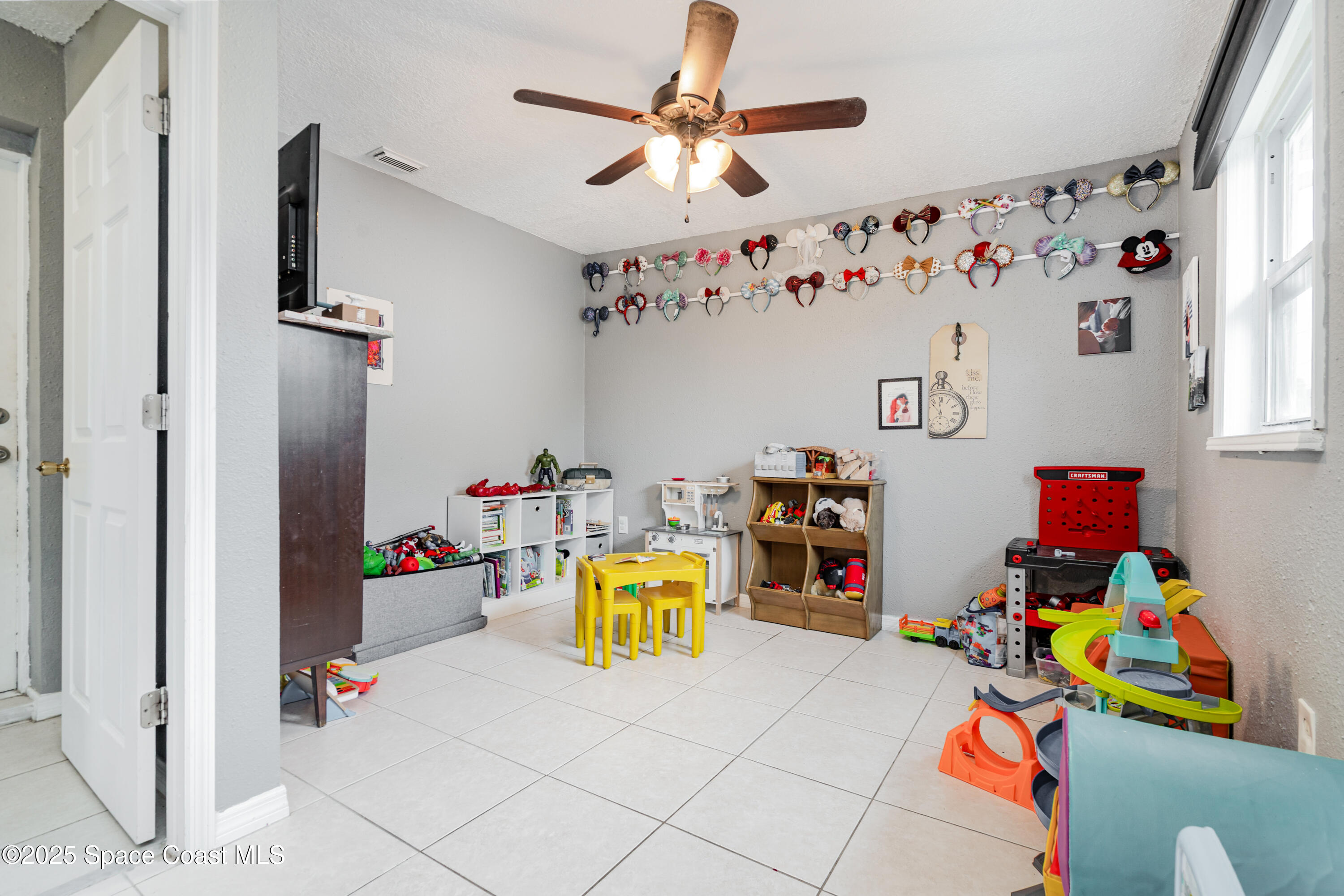 4120 Duke Street Melbourne, FL 32901 - Photo 20 of 29 a bedroom with a bed and a chandelier