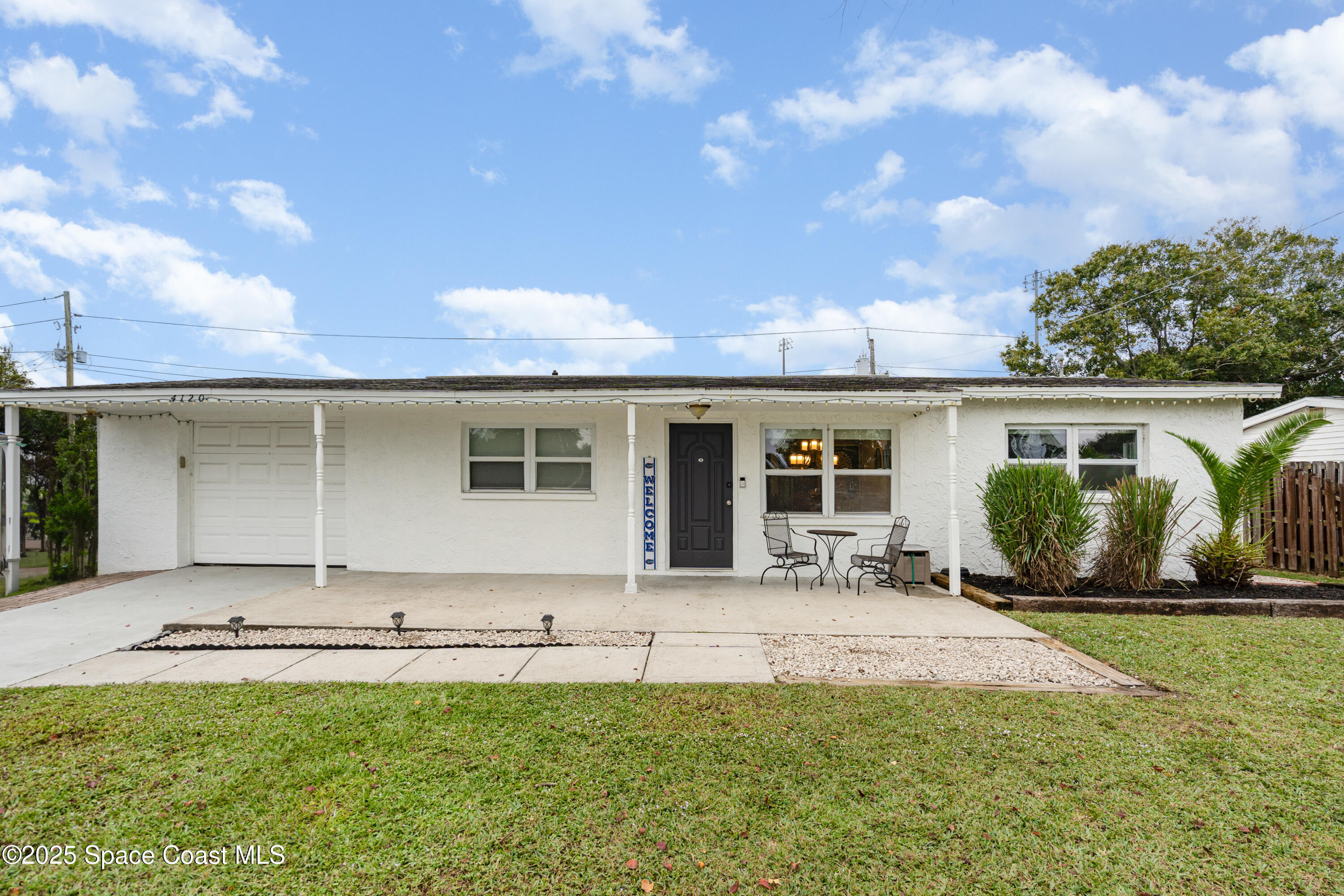 4120 Duke Street Melbourne, FL 32901 - Photo 2 of 29 a front view of a house with a garden and yard