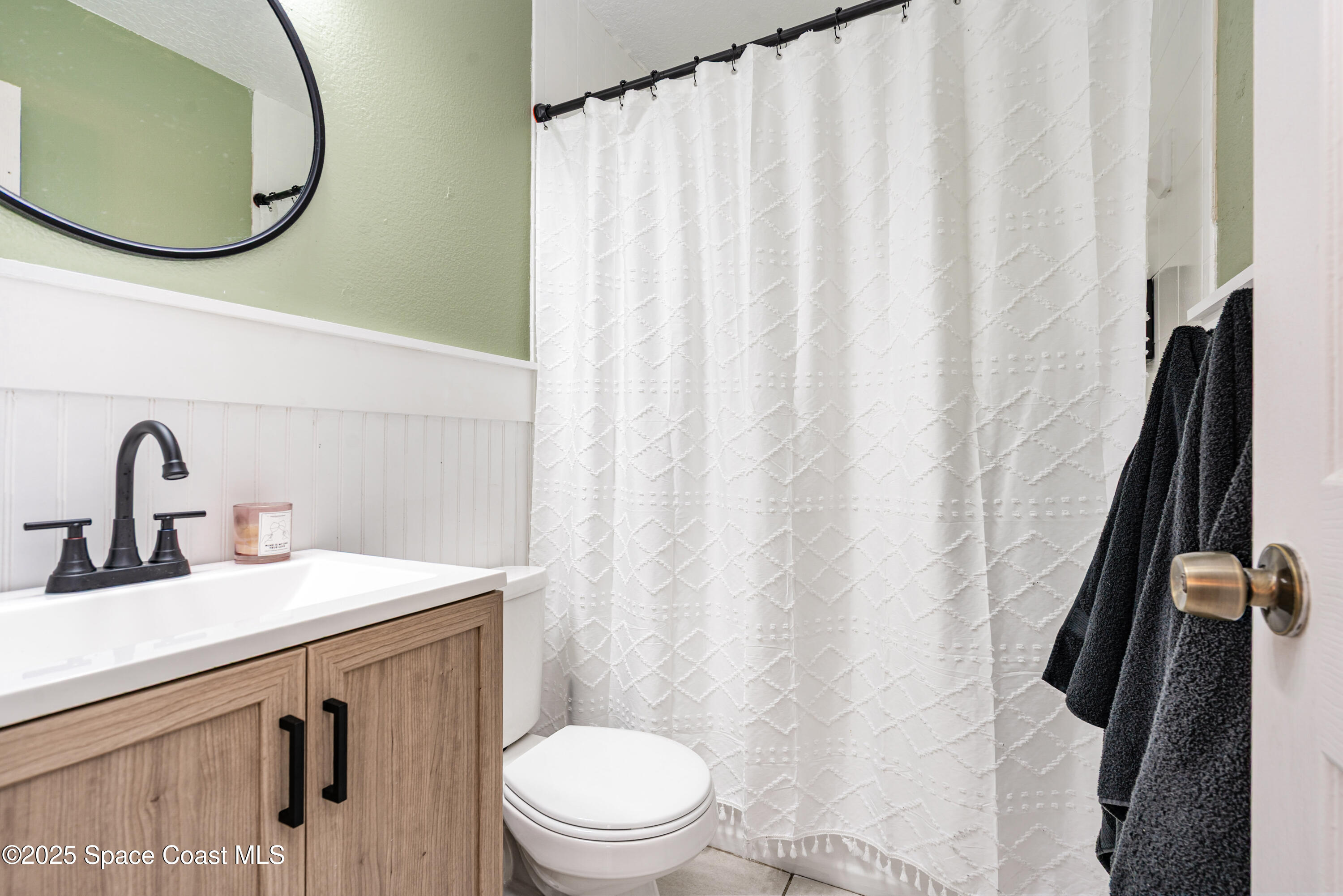4120 Duke Street Melbourne, FL 32901 - Photo 22 of 29 a bathroom with a sink a toilet and a mirror