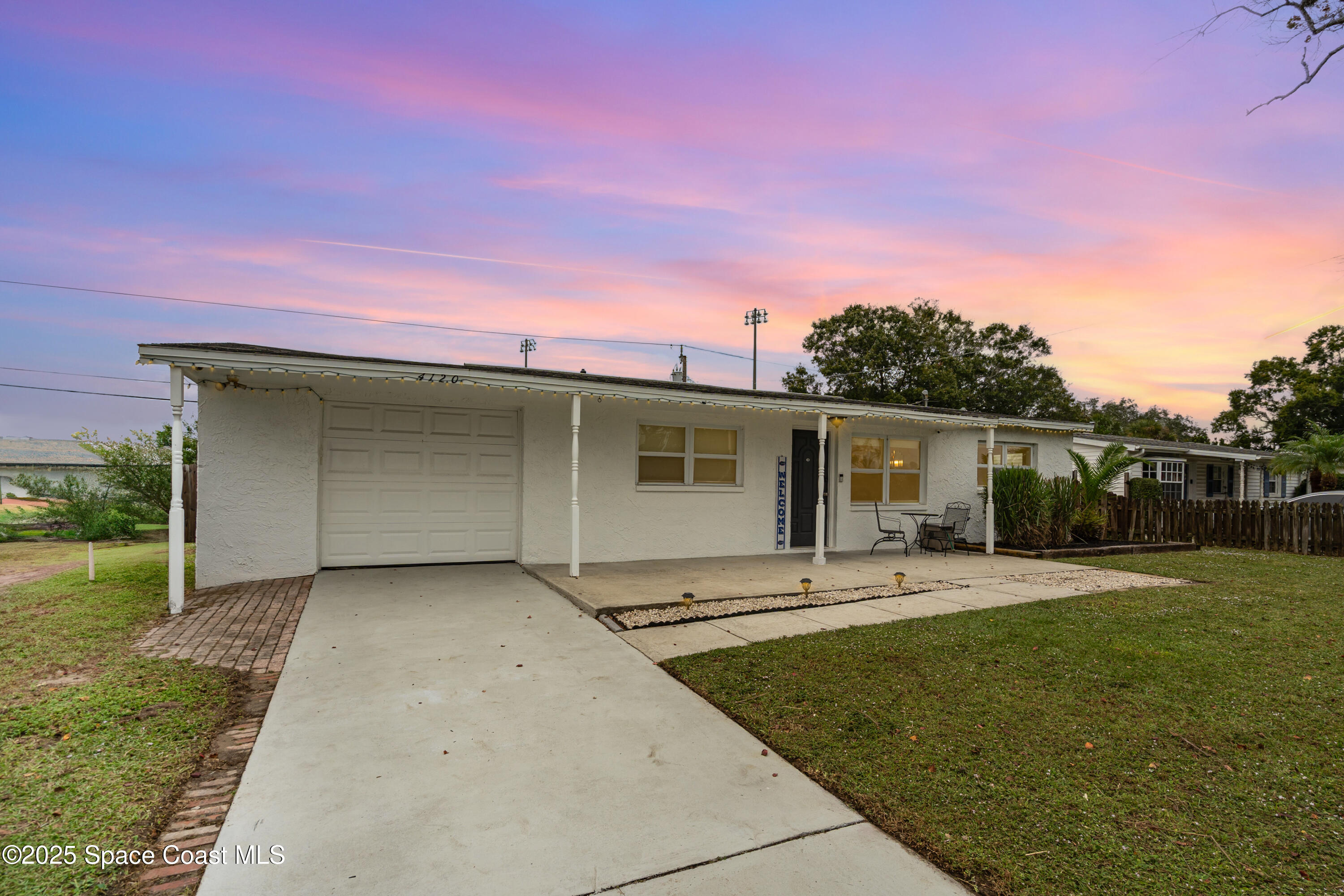 4120 Duke Street Melbourne, FL 32901 - Photo 3 of 29 a front view of a house with a yard and garage