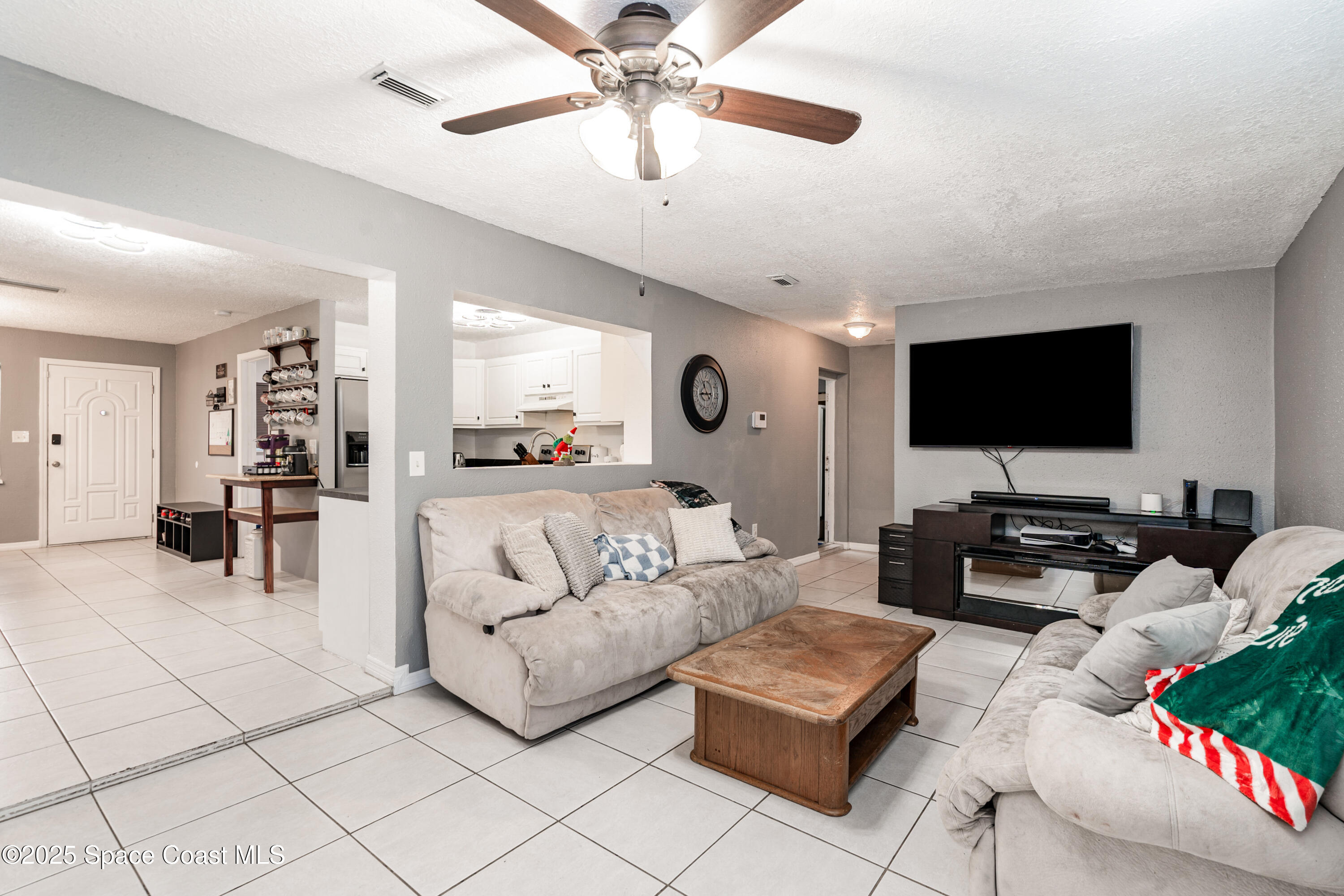 4120 Duke Street Melbourne, FL 32901 - Photo 9 of 29 a living room with furniture and a flat screen tv