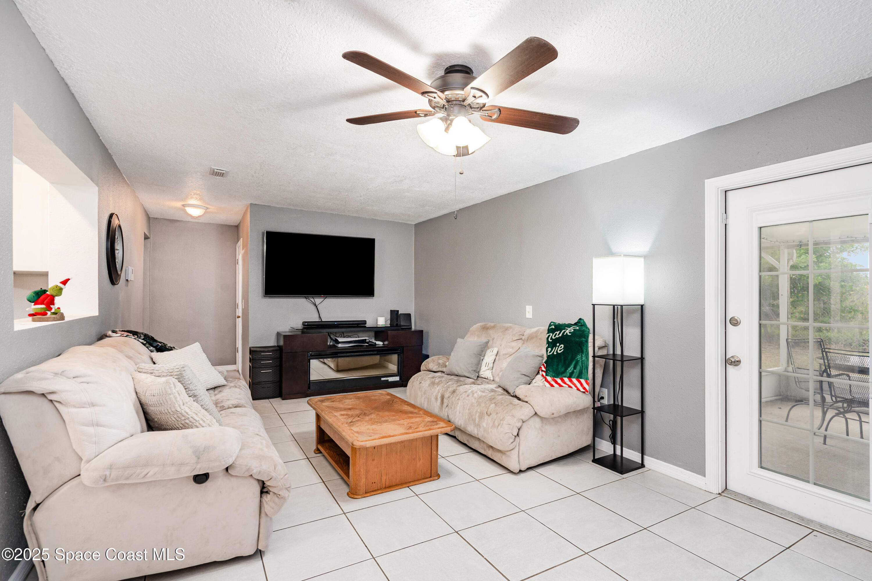 4120 Duke Street Melbourne, FL 32901 - Photo 10 of 29 a living room with furniture and a flat screen tv