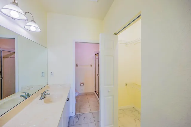 a spacious bathroom with a tub sink and mirror