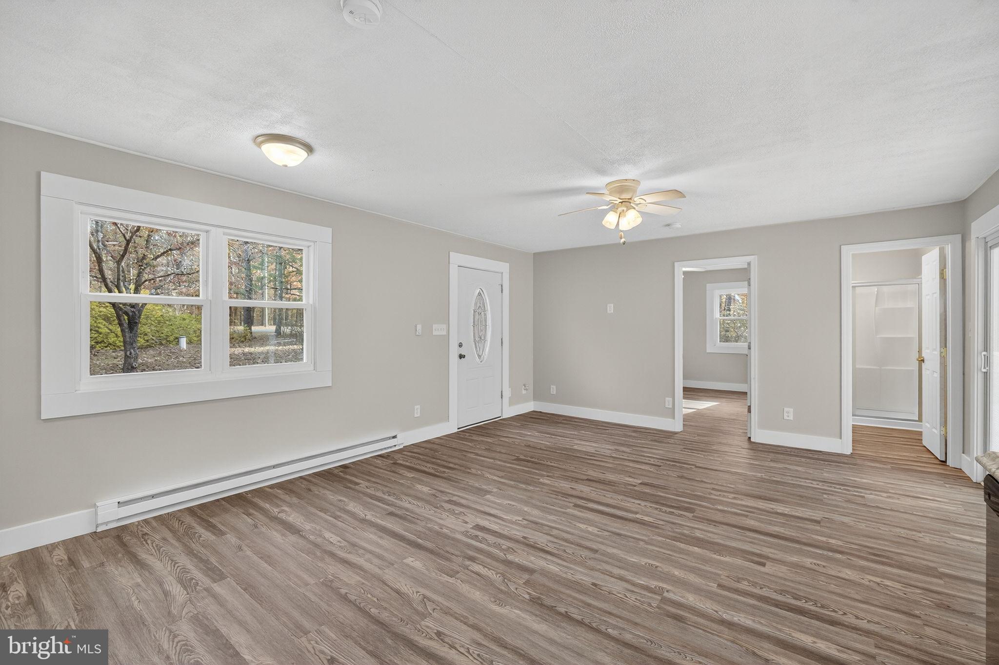 19239 Mountain Track Road Orange, VA 22960 - Photo 7 of 19 a view of an empty room with wooden floor and a window