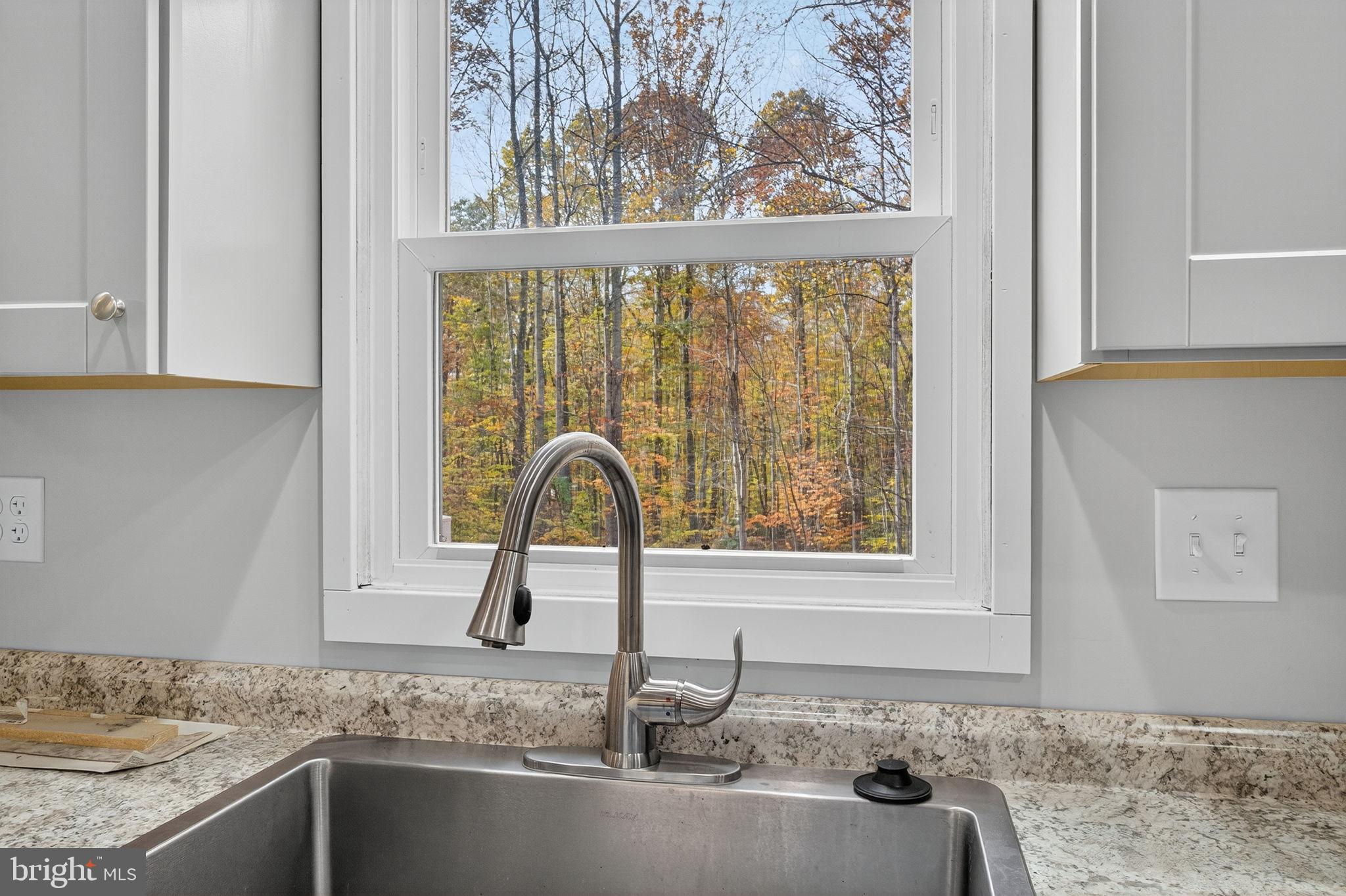 19239 Mountain Track Road Orange, VA 22960 - Photo 10 of 19 a kitchen with granite countertop a sink and a window
