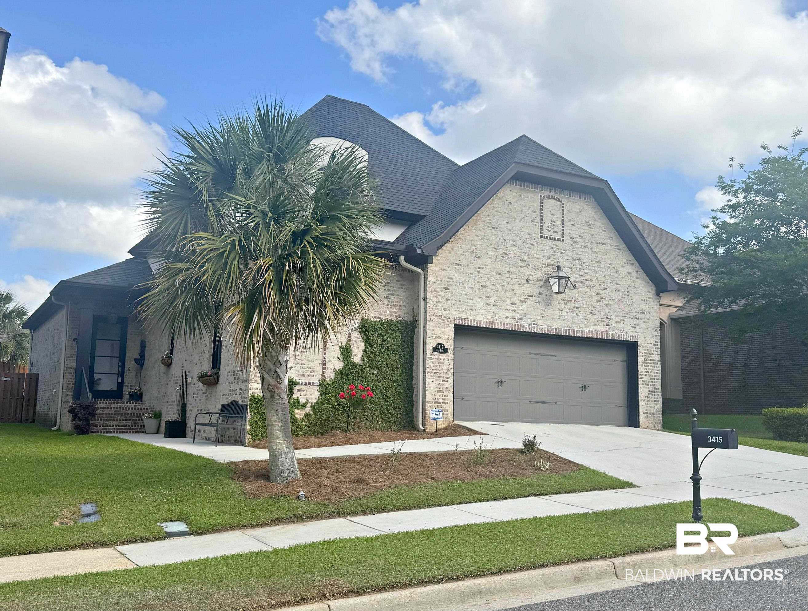 3415 Rue Royal Mobile, AL 36693 - Photo 1 of 31 View of front of property featuring driveway, brick siding, a front lawn, and stone siding