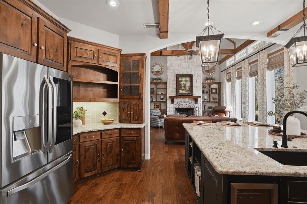 9651 Yellow Rose Lane Pilot Point, TX 76258 - Photo 15 of 38 a kitchen with stainless steel appliances granite countertop a sink refrigerator and cabinets