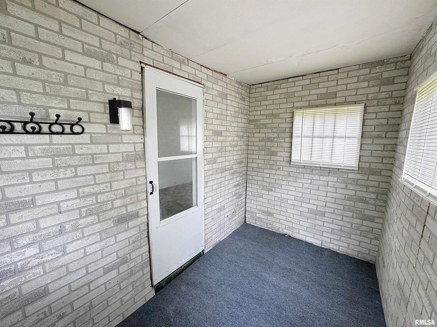 204 Main Avenue Matherville, IL 61263 - Photo 4 of 27 a view of an empty room with brick wall and a window