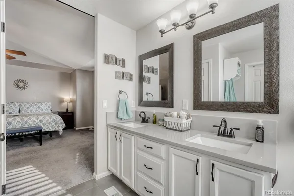 a en suite bathroom with double sink and a mirror