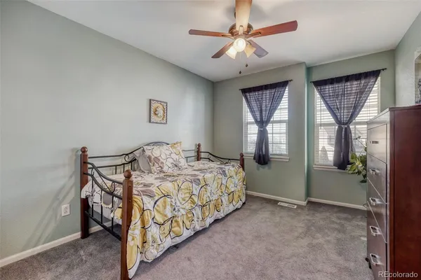 a bathroom with a granite countertop double vanity sink and a mirror