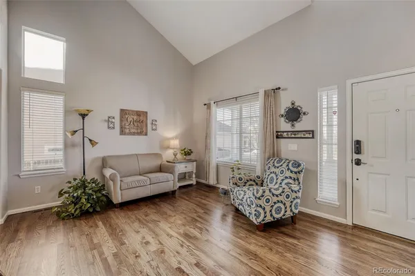a living room with furniture and wooden floor