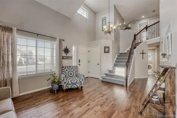 a view of entryway with wooden floor and stairs