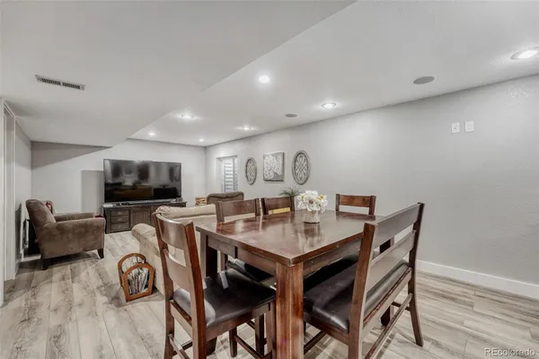 a view of a dining room with furniture and a flat screen tv