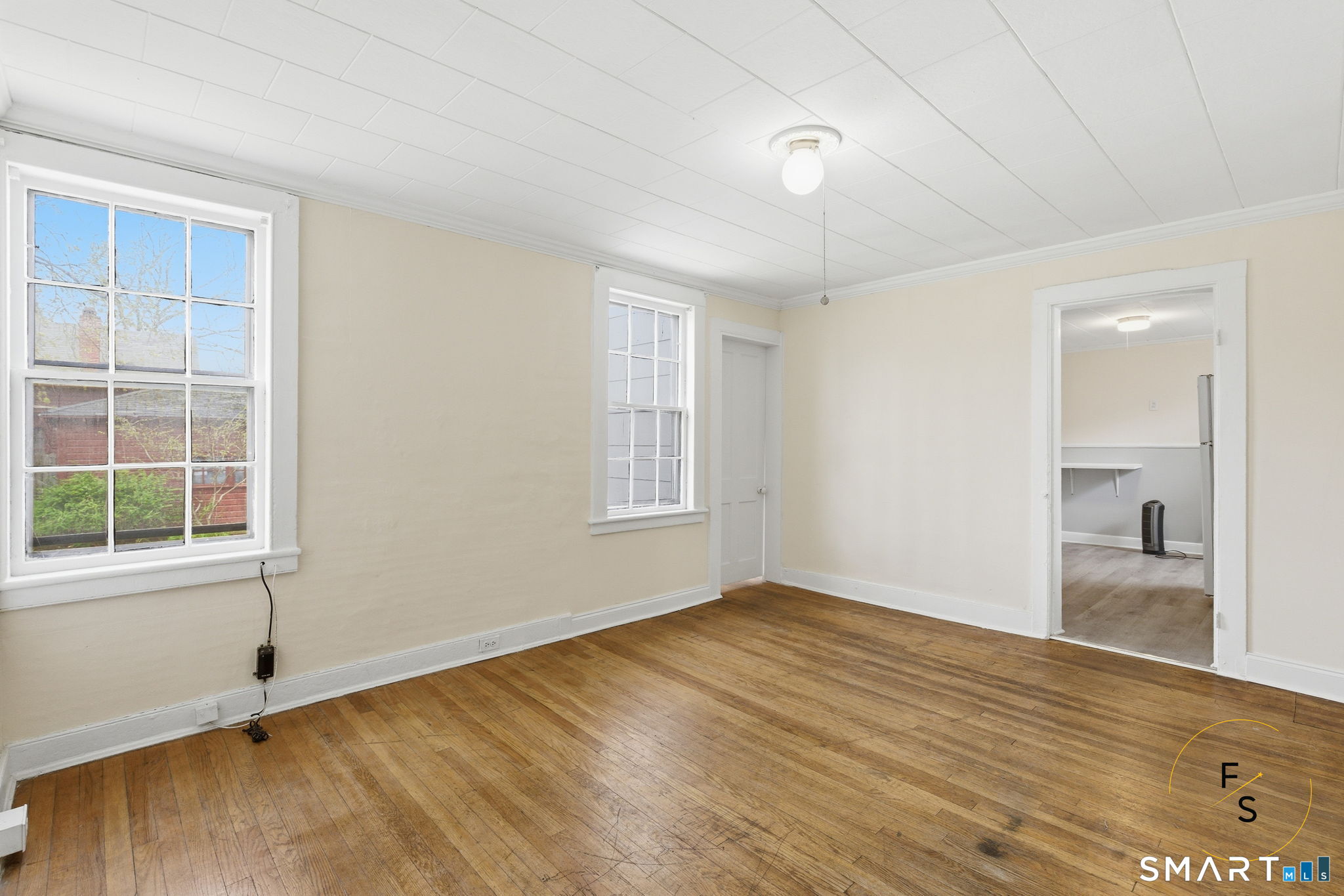 119 Williams Street Norwich, CT 06360 - Photo 11 of 40 a view of an empty room with wooden floor and a window