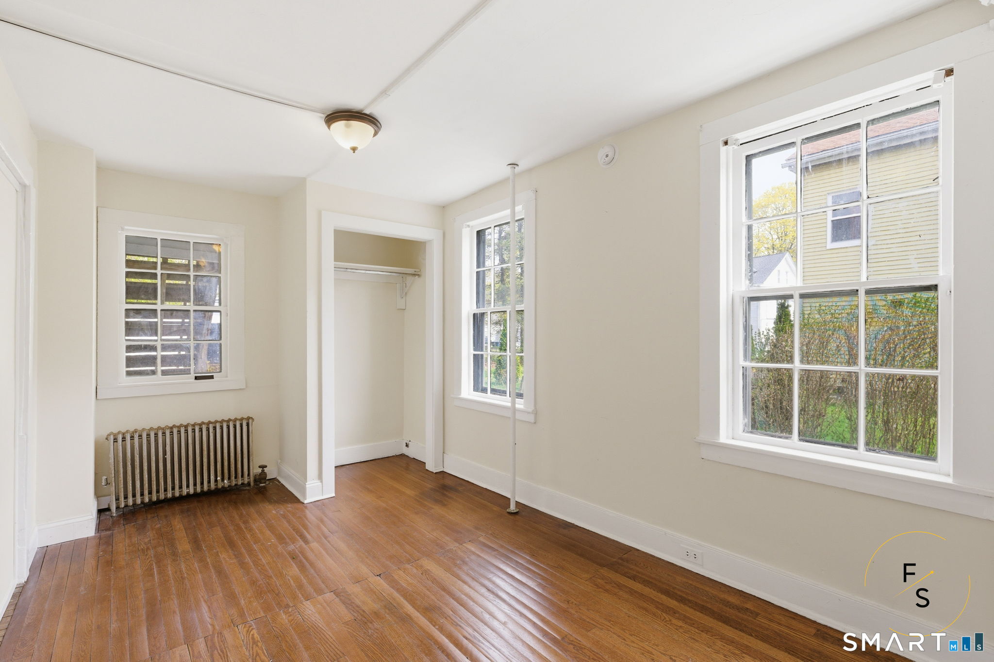 119 Williams Street Norwich, CT 06360 - Photo 12 of 40 an empty room with wooden floor and windows