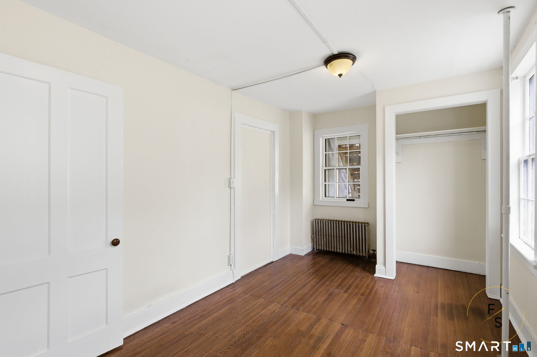 119 Williams Street Norwich, CT 06360 - Photo 13 of 40 a view of an empty room and wooden floor