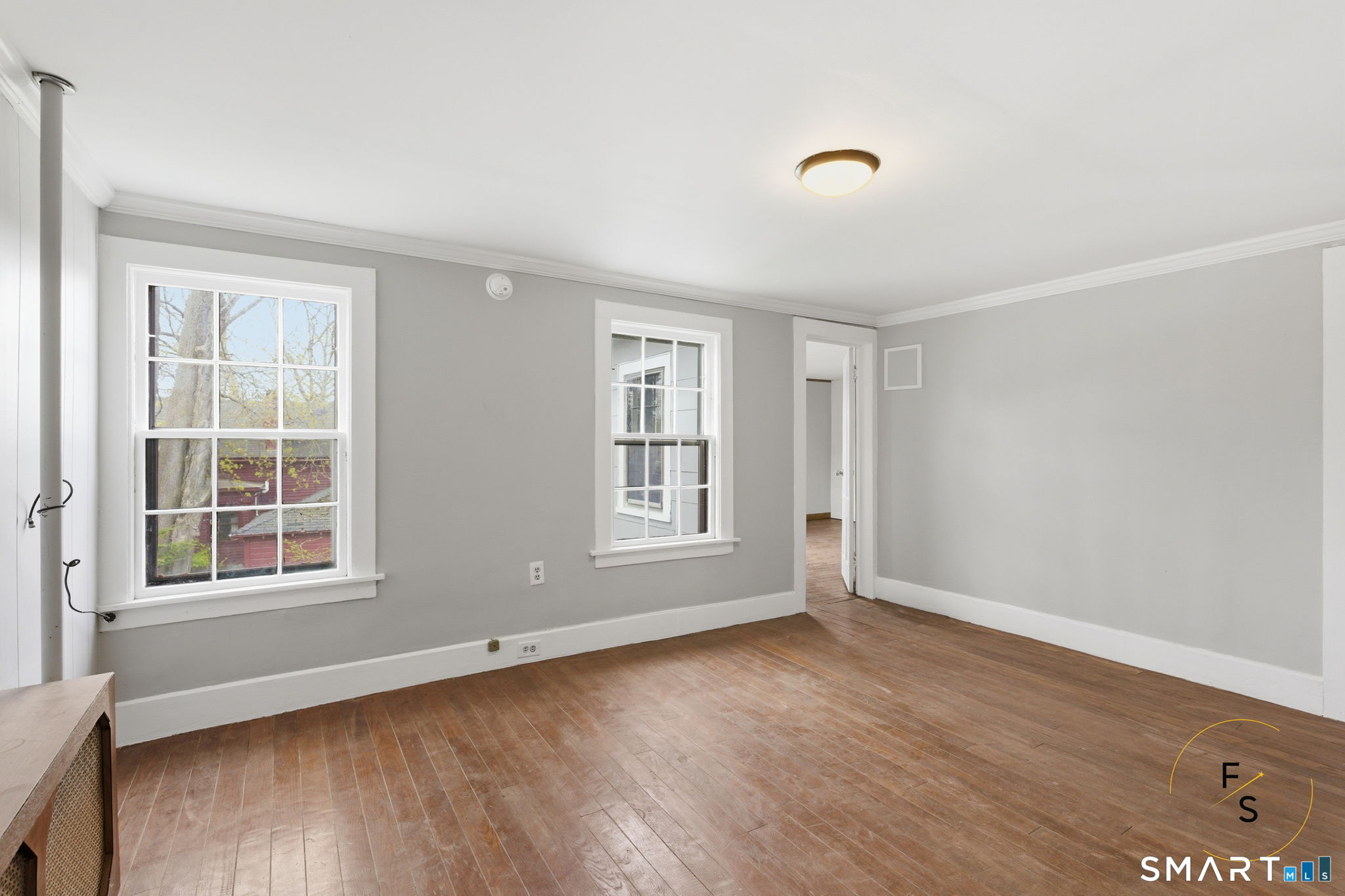 119 Williams Street Norwich, CT 06360 - Photo 23 of 40 an empty room with wooden floor and windows