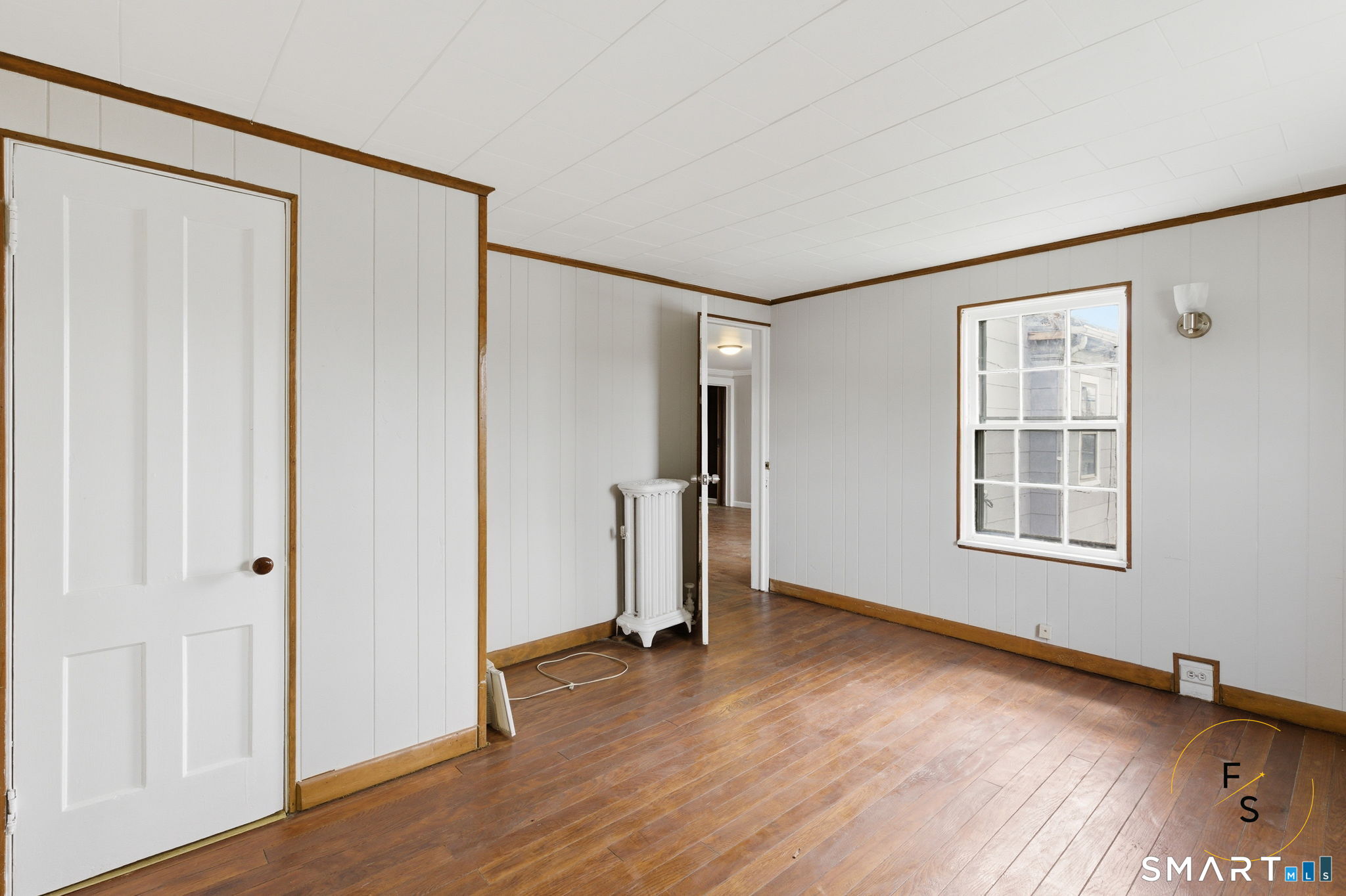 119 Williams Street Norwich, CT 06360 - Photo 26 of 40 a view of an empty room with wooden floor and a window
