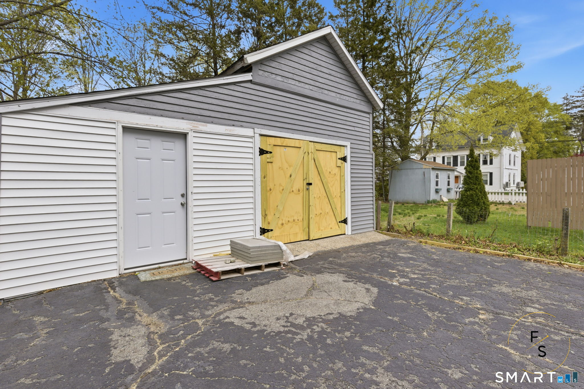 119 Williams Street Norwich, CT 06360 - Photo 39 of 40 a view of a house with a yard and garage