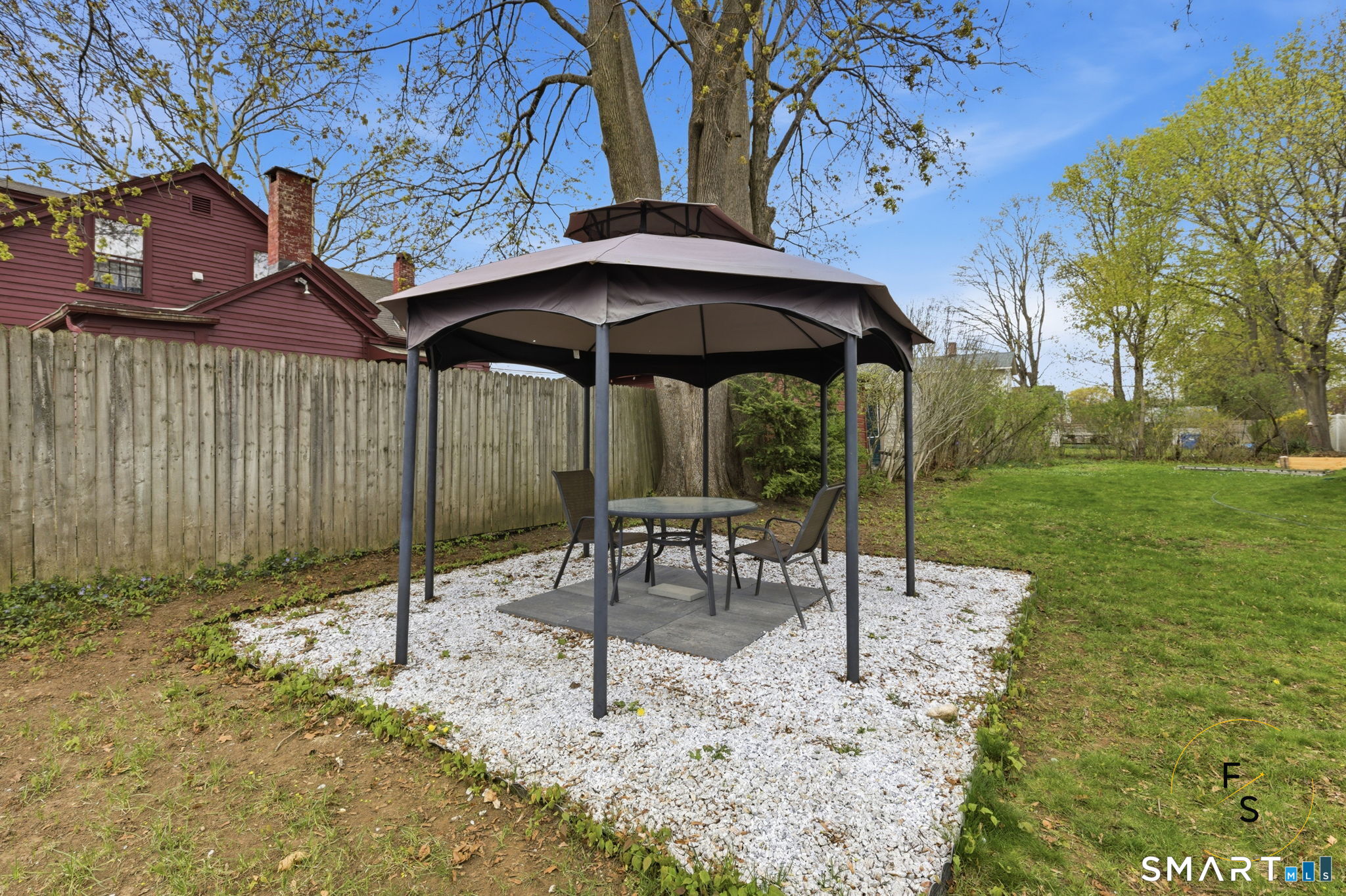 119 Williams Street Norwich, CT 06360 - Photo 40 of 40 a view of a table and chairs under an umbrella