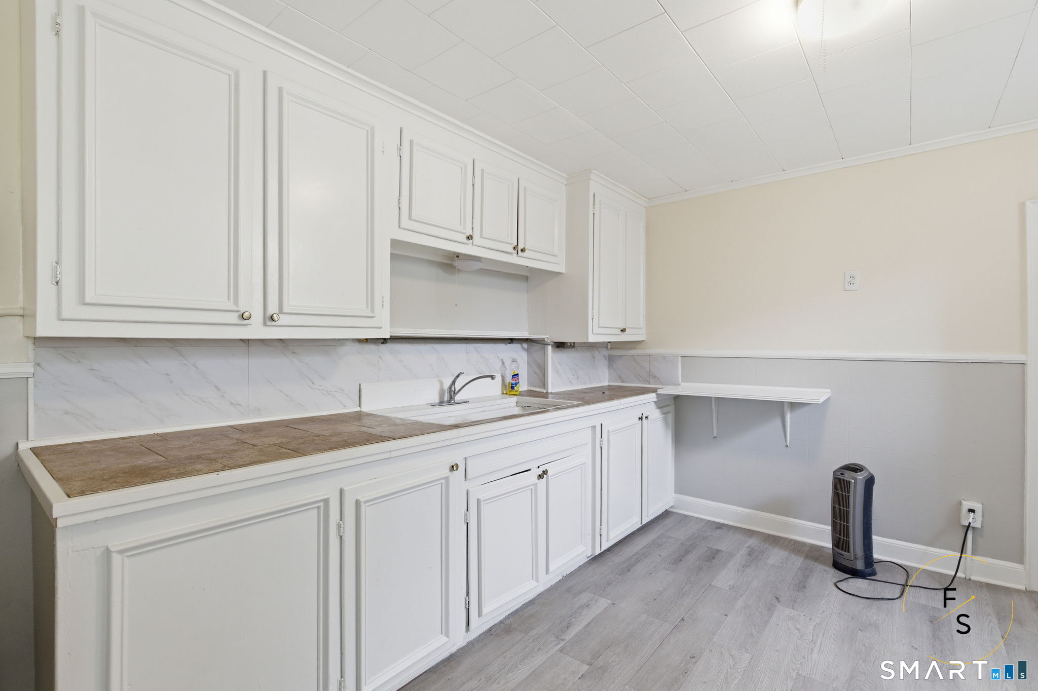 119 Williams Street Norwich, CT 06360 - Photo 4 of 40 a kitchen with white cabinets appliances and sink