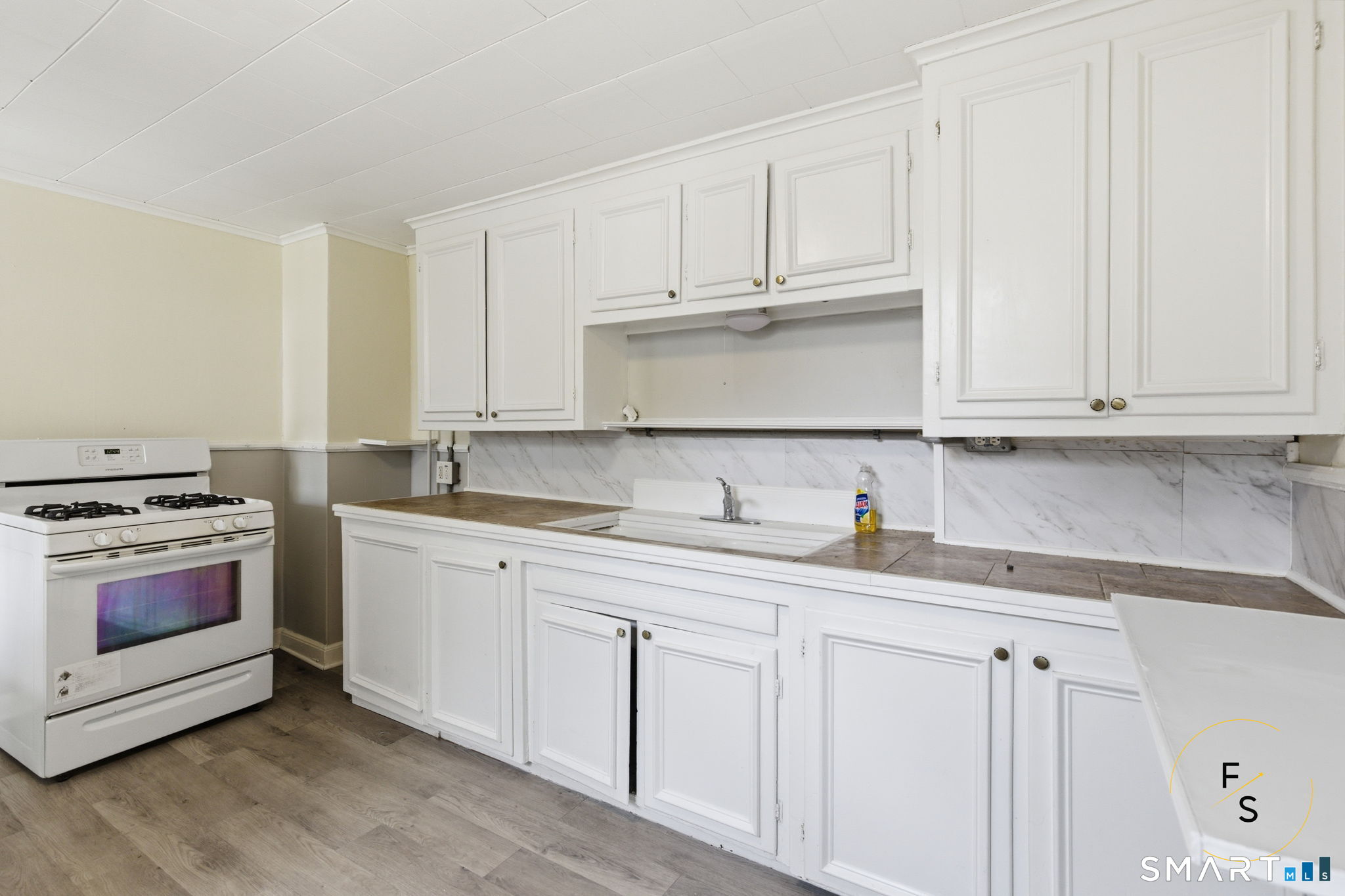 119 Williams Street Norwich, CT 06360 - Photo 5 of 40 a kitchen with granite countertop white cabinets and stainless steel appliances