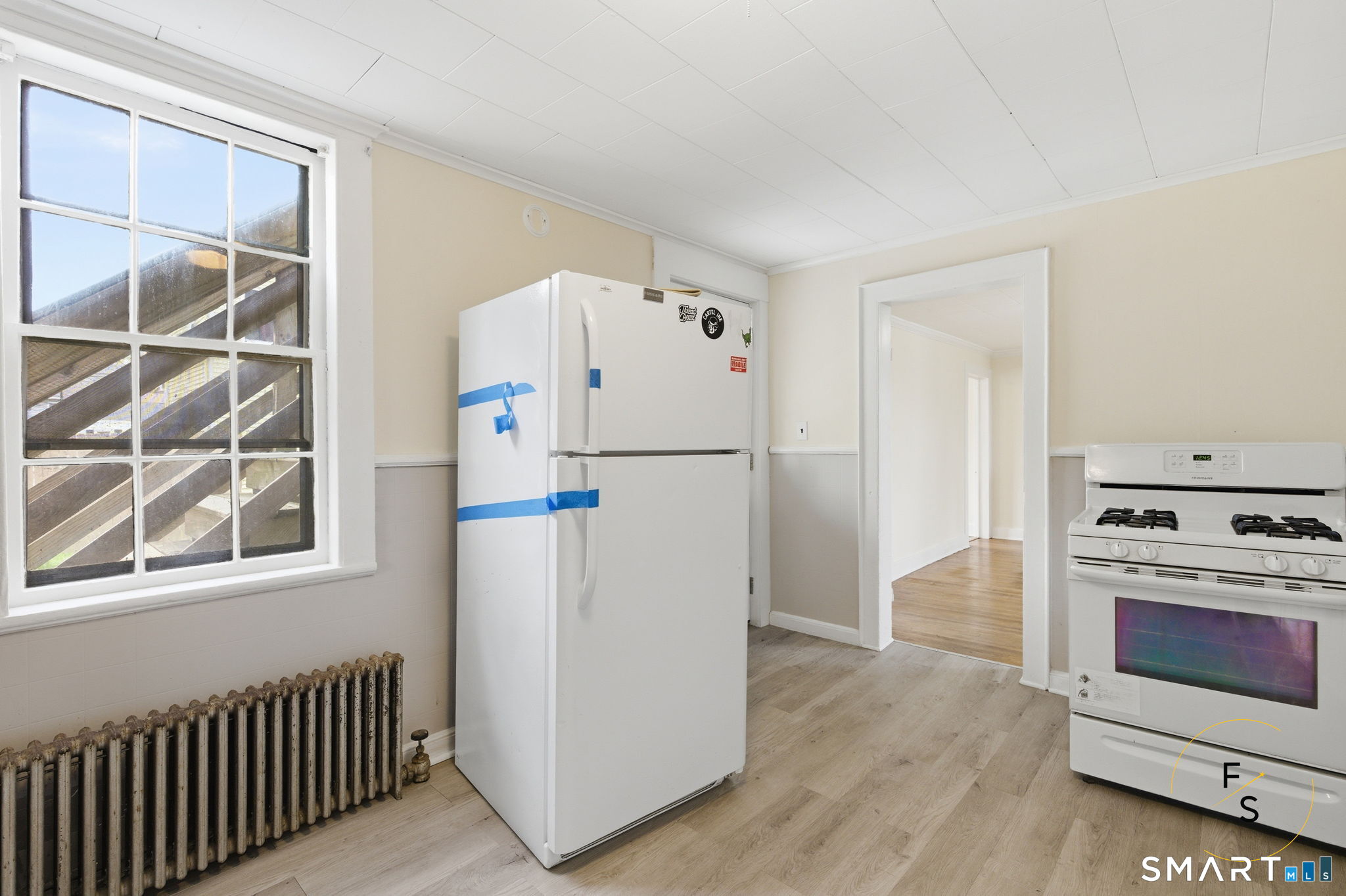 119 Williams Street Norwich, CT 06360 - Photo 7 of 40 a white refrigerator freezer and a stove sitting inside of a kitchen