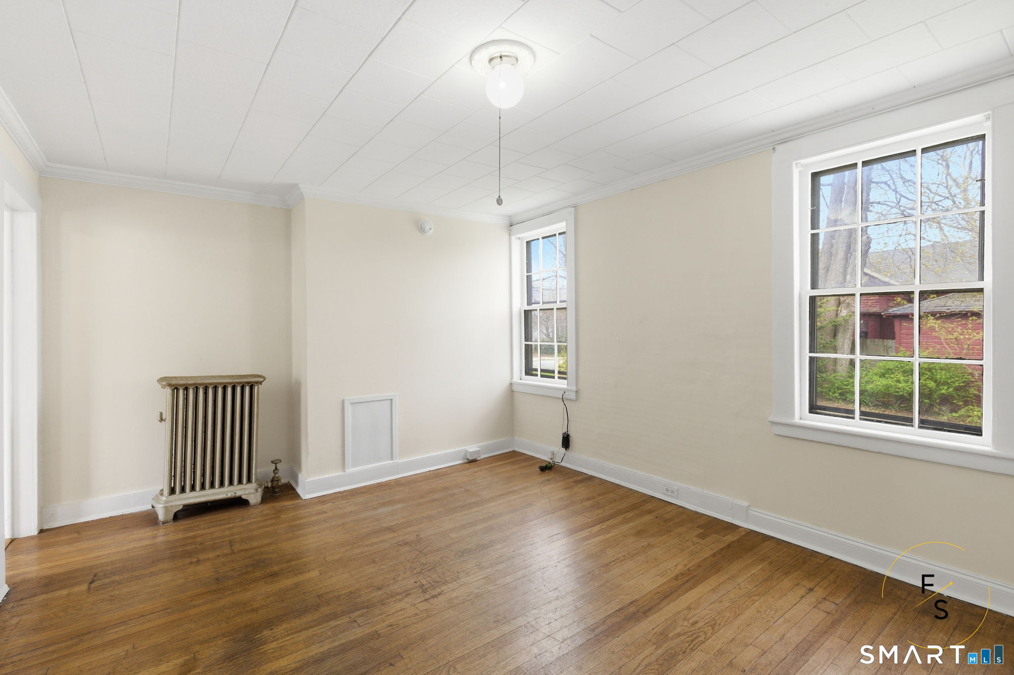 119 Williams Street Norwich, CT 06360 - Photo 8 of 40 an empty room with wooden floor cabinet and windows