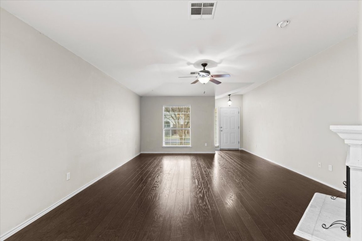 13438 Moscow Trail Austin, TX 78729 - Photo 14 of 40 an empty room with wooden floor and windows