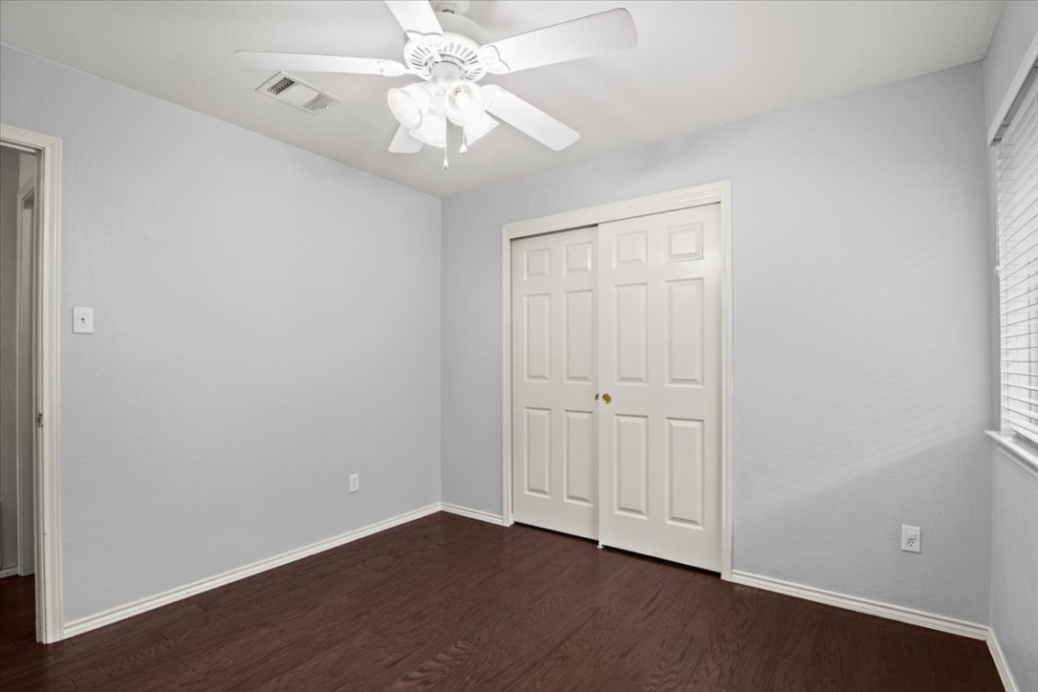 13438 Moscow Trail Austin, TX 78729 - Photo 28 of 40 an empty room with wooden floor fan and windows