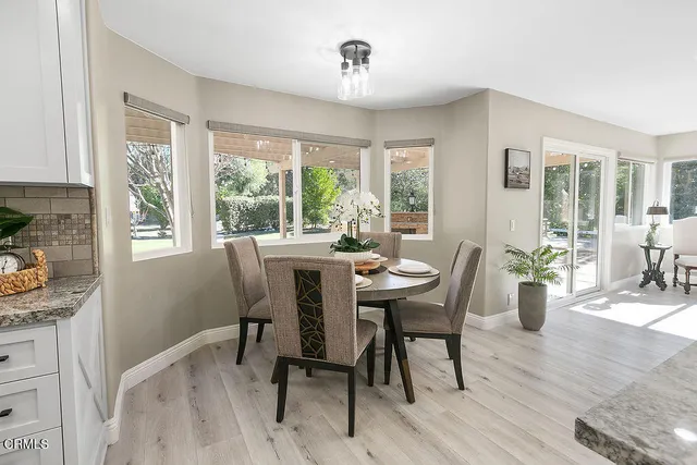a living room with stainless steel appliances kitchen island granite countertop furniture wooden floor and a view of kitchen