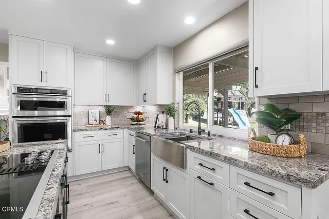 a view of a workspace with furniture and wooden floor