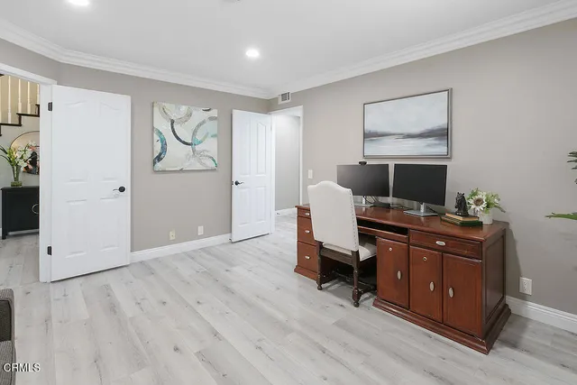 a bedroom with a bed and a potted plant