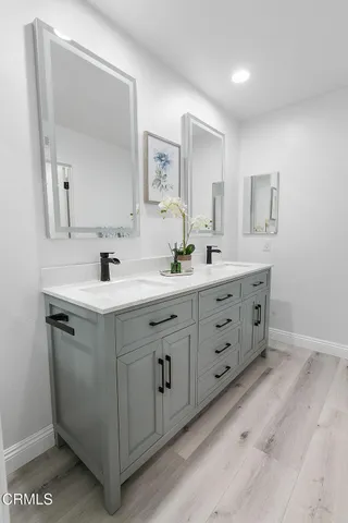 a large white bed sitting in a bedroom next to a window