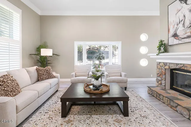 a living room with furniture a window and a fireplace