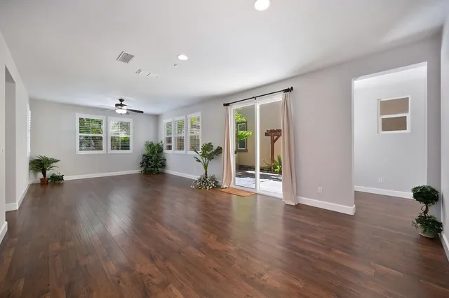 a view of a livingroom with wooden floor and furniture