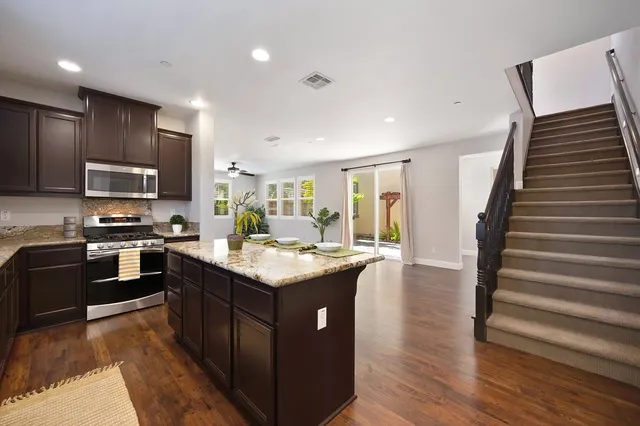 a kitchen with a stove sink and cabinets