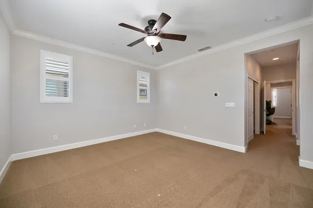 a view of an empty room with a ceiling fan