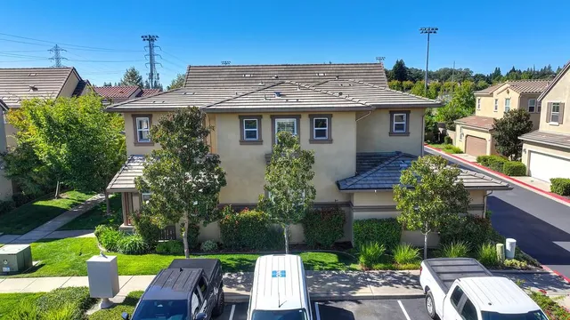 a view of a house with a yard and furniture