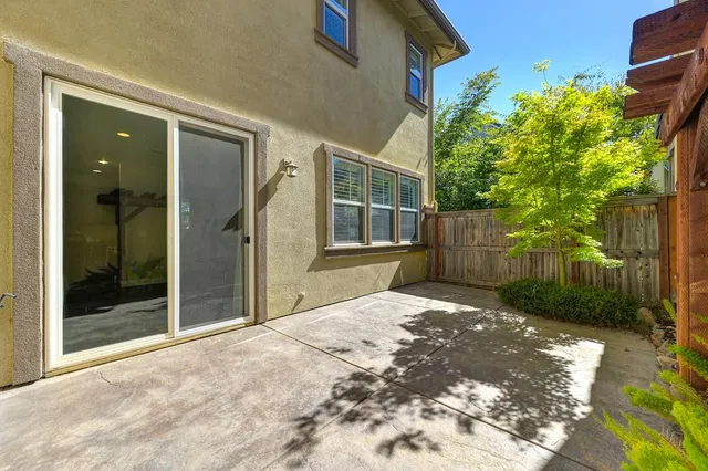 a backyard of a house with plants and trees