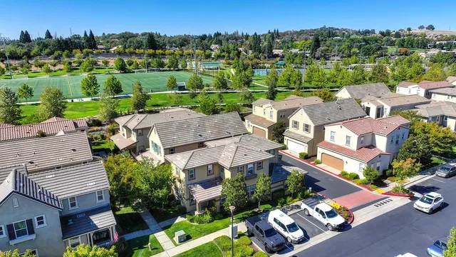 an aerial view of a house with a garden and lake view