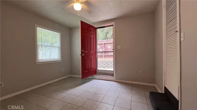 an empty room with windows and closet