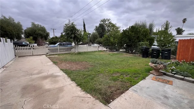 a park view with potted plants and large trees