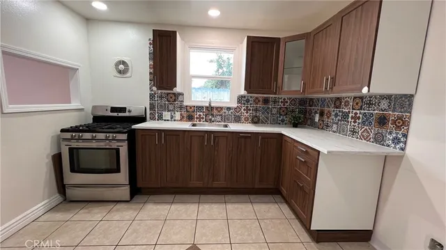 a kitchen with a sink stove and cabinets