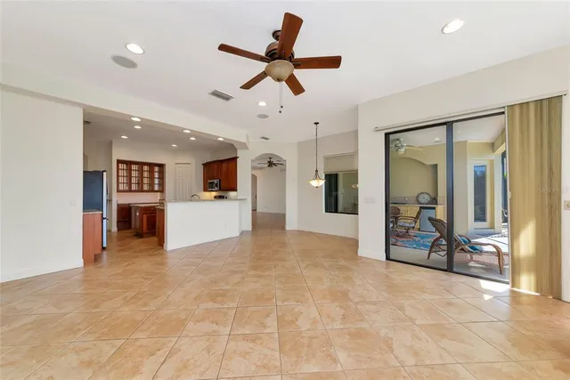 a view of a livingroom with a ceiling fan and window