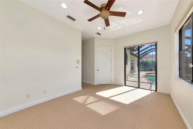 a bathroom with a granite countertop sink a mirror and a toilet