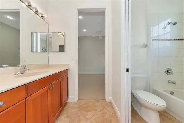 an empty room with wooden floor chandelier fan and windows