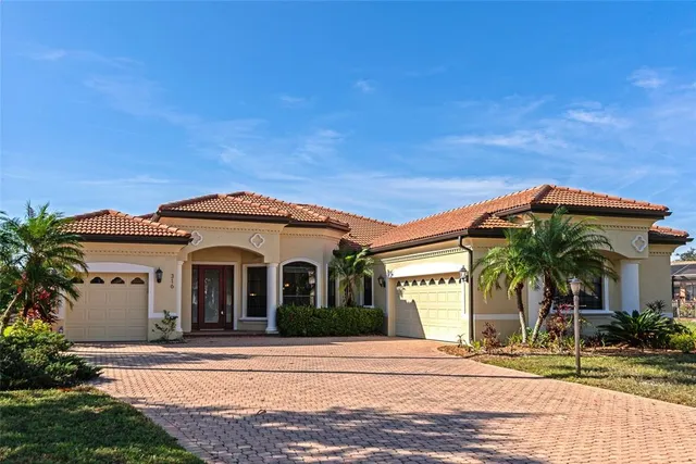a view of an empty room with window and chandelier fan