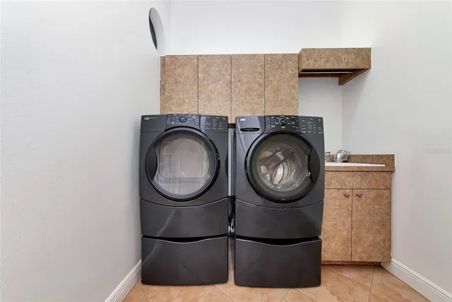 a living room with furniture a flat screen tv and a large window